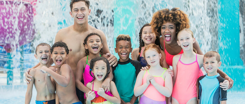 Youth group standing in front of waterfall